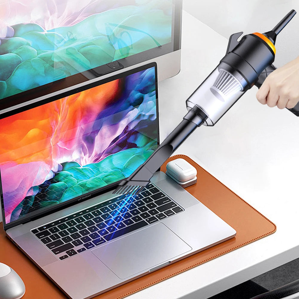 Laptop on a desk with a hand using a vacuum cleaner to clean it | Origin Zero