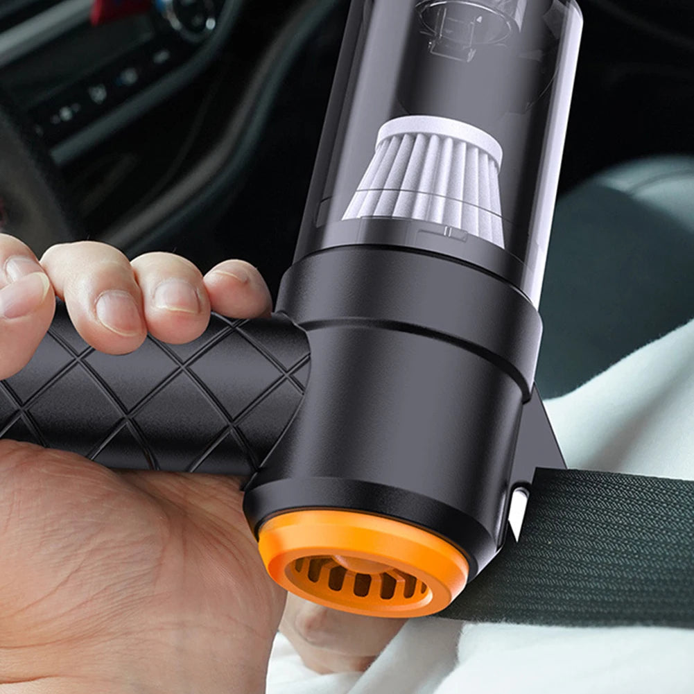 Hand holding a black and orange car air freshener with a car interior  | Origin Zero