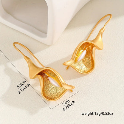 Gold earrings with measurements and weight details on a light background
